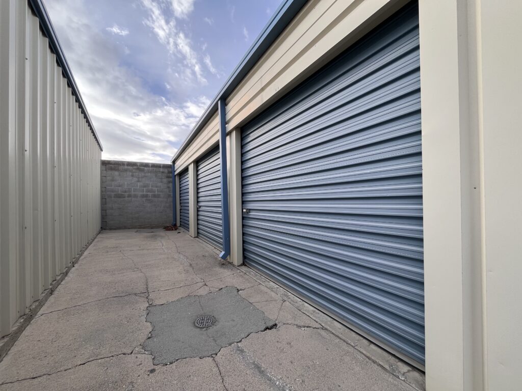 Blue garage doors in an empty alley.